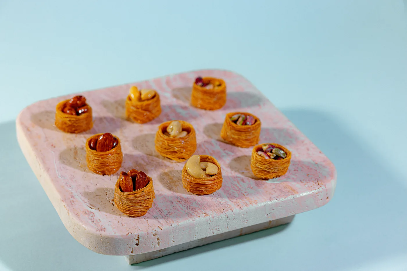 Mini nut tartlets on a stone tray, from Exception Sweets