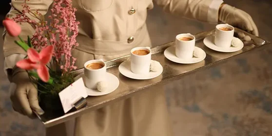 Hospitality photo: a coffee tray served with gloved hands