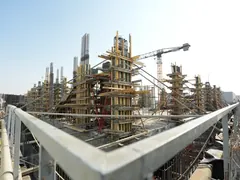 A construction site: columns, formwork, and a crane, from our construction photography
