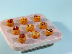 Mini nut tartlets on a stone tray, from Exception Sweets