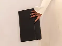 Product photo: a black leather folder