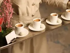 Hospitality photo: a coffee tray served with gloved hands